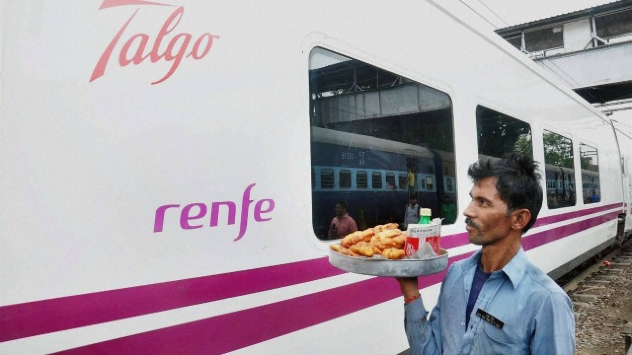 Vendor walks near the Spanish train Talgo