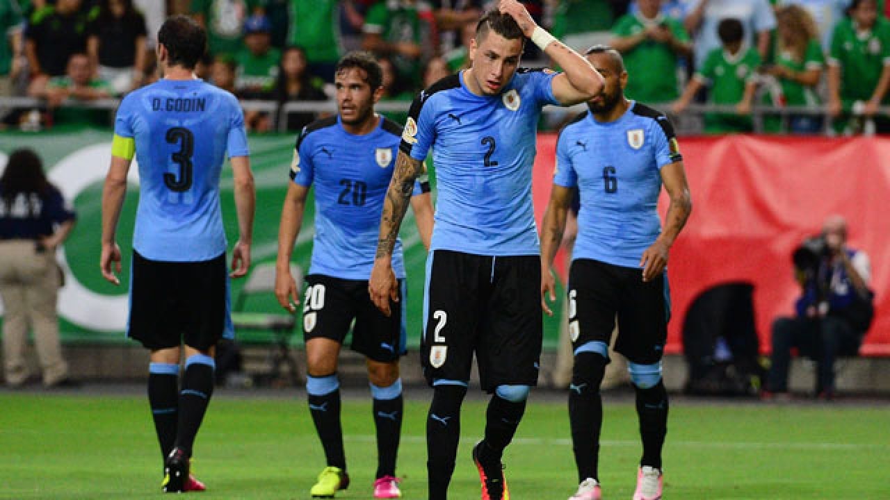  The image shows the Uruguay team in blue uniforms lined up on the field during a Copa America match.
