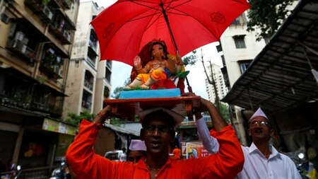 Man carries a Ganesh idol