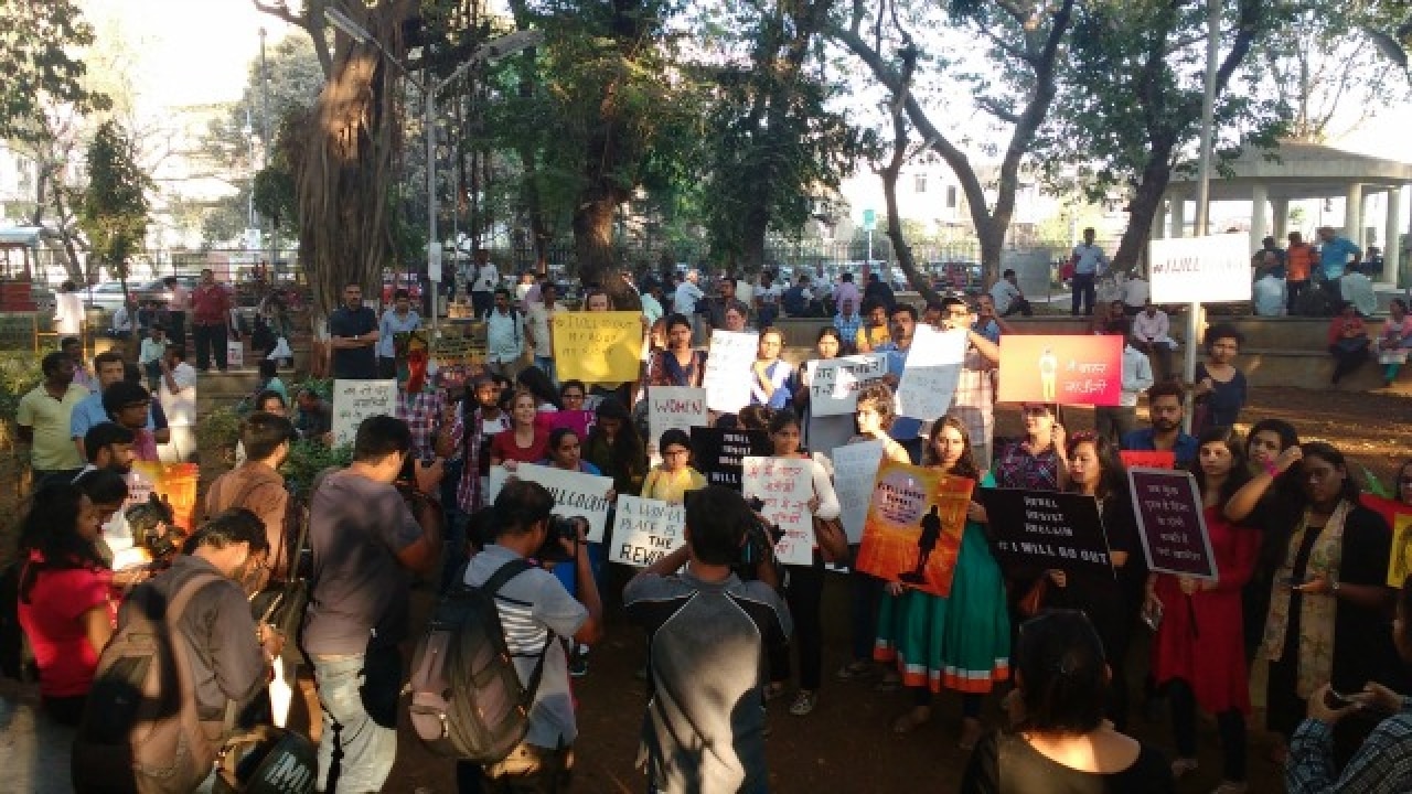 Women hold up signs with strong messages