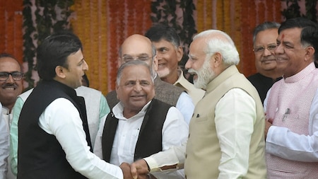 Former UP CM Akhilesh Yadav shakes hand with Narendra Modi, father Mulayam Singh looks on