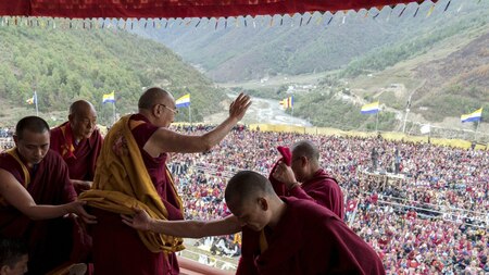 Dalai Lama waves to his supporters