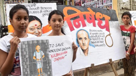 Girls hold painting of Kulbhushan Jadhav
