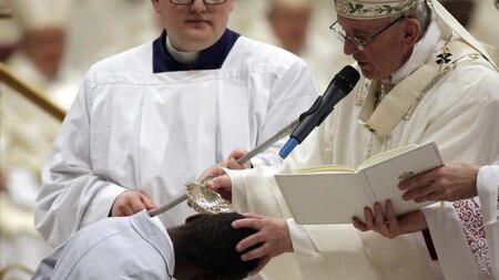 Pope Francis baptizes a boy