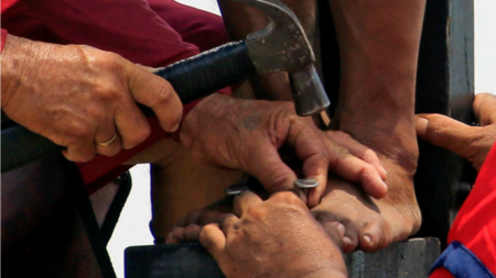 Devotee being nailed to a cross