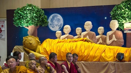 Buddhists praying by a Buddha statue (AFP)