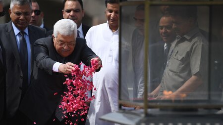 Palestine President Mahmud Abbas sprinkles rose petals