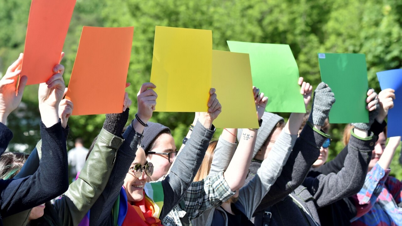 Ukraine LGBT hold papers in color of rainbow