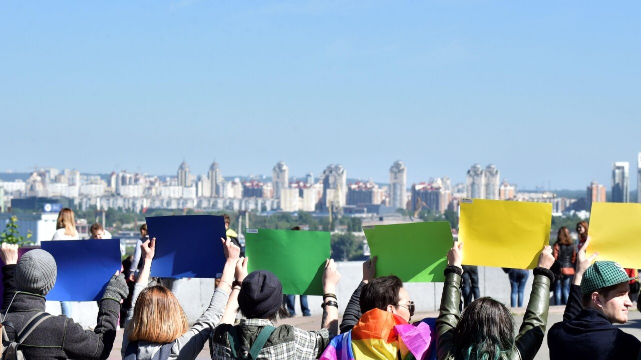 Ukraine LGBT hold papers in color of rainbow