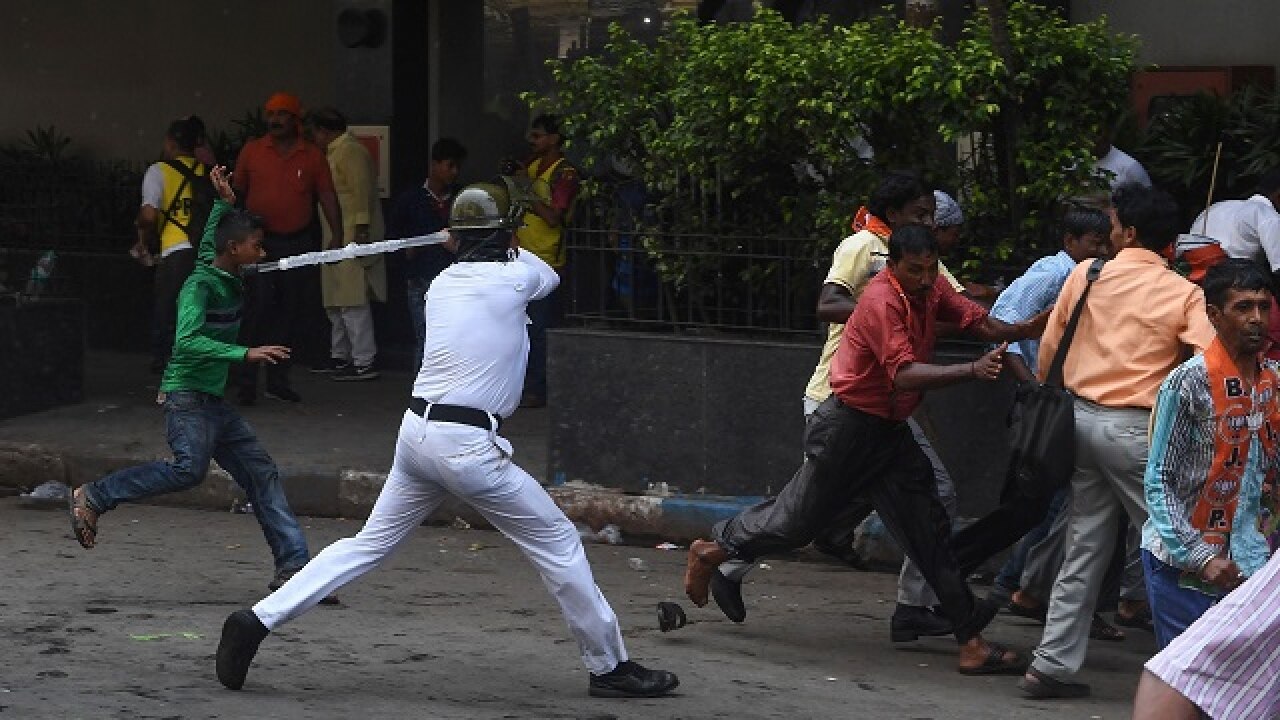 Policeman charges at activists