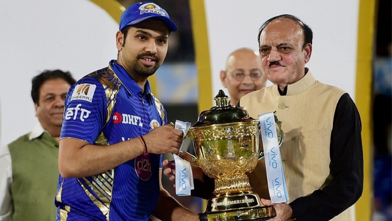 Mumbai Indians skipper Rohit Sharma lays his hands on the IPL trophy