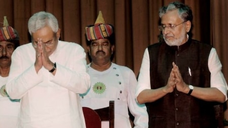 Nitish Kumar and Shushil Kumar Modi greet the gathering after they were sworn-in as Bihar Chief Minister and Dy Chief Minister