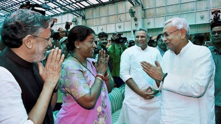 Nitish Kumar and senior BJP leader Sushil Kumar Modi share a lighter moment at an oath taking ceremony