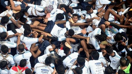 Govindas and devotees collapse as they attempt to break a Dahi Handi