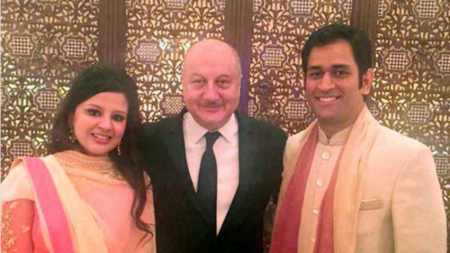 Anupam Kher (C) and MS Dhoni (R) are all smiles at the wedding bash