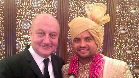 Anupam Kher (L) poses with Suresh Raina (R)