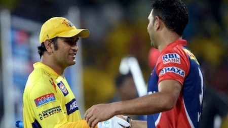 Chennai Super Kings’ Skipper MS Dhoni with Delhi Daredevils' Yuvraj Singh after win the IPL-2015 match