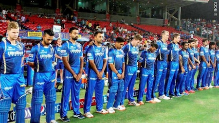 Rajasthan Royals players stand for a minute silence as they pay tribute to commentator Richie Benaud before the start of their IPL match against Kings XI Punjab in Pune on Friday.