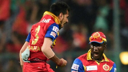 Royal Challengers Bangalore player Y Chahal with team mates celebrate the wicket of David Warner during IPL 8 match against Sunrisers Hyderabad at Chinnaswamy Stadium in Bengaluru on Monday.