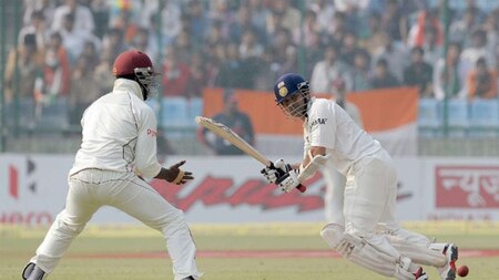 Sachin sweeping the ball away while West Indies' Dwayne Bravo looks on, in his last Test at Wankhede Stadium, Mumbai