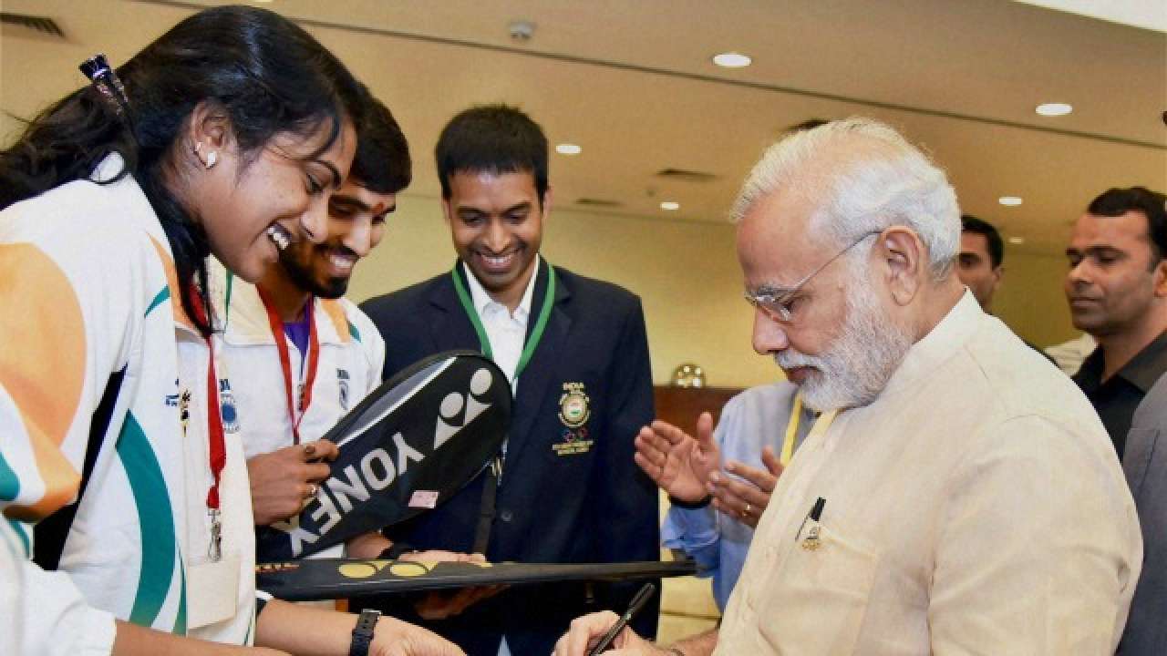 Modi signing autographs for Indian athletes