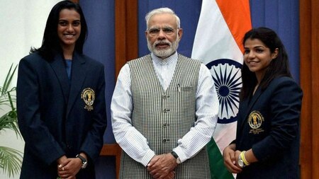 PV Sindhu (L) and Sakshi Malik with Modi