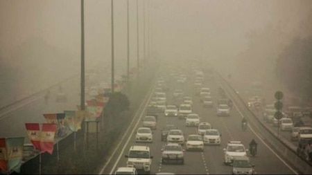 Traffic paves its way through dense smog