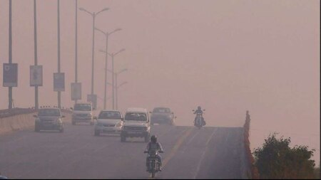 Traffic drives through smog