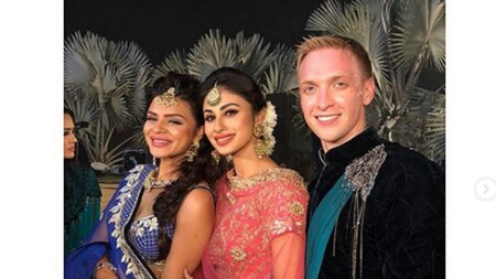 Mouni Roy poses with the couple