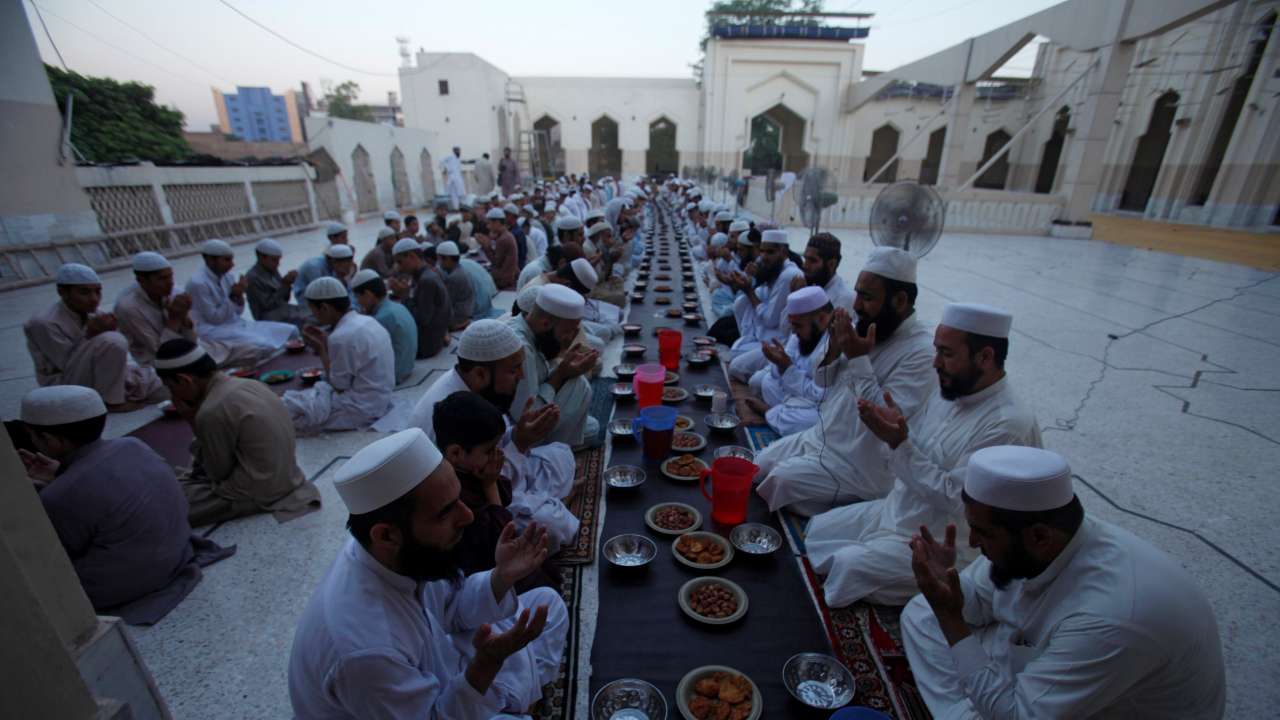People pray before breaking fast