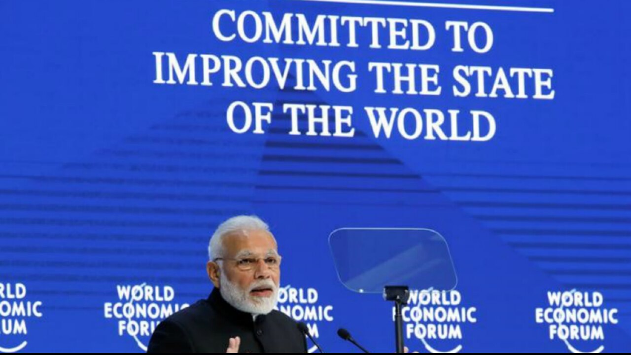 PM Modi gestures as he speaks at the World Economic Forum