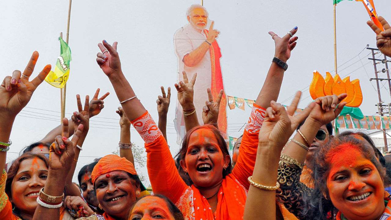 BJP supporters wave party flag
