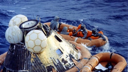 Astronauts Mike Collins, Neil Armstrong and Edwin Aldrin get into the life raft