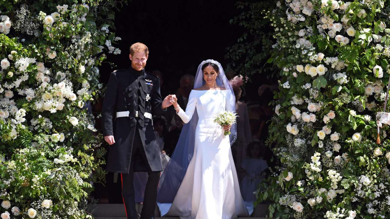 Prince Harry and Meghan Markle post exchanging their wedding vows