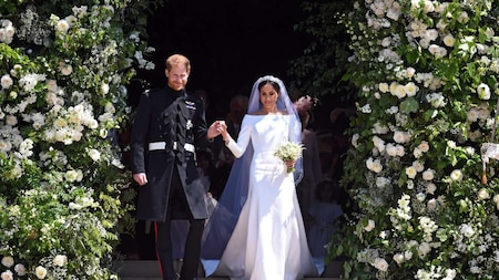 Prince Harry and Meghan Markle post exchanging their wedding vows