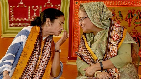 West Bengal Chief Minister Mamata Banerjee speaks with Bangladeshi Prime Minister Sheikh Hasina during the annual convocation of