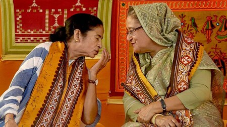 West Bengal Chief Minister Mamata Banerjee speaks with Bangladeshi Prime Minister Sheikh Hasina during the annual convocation of