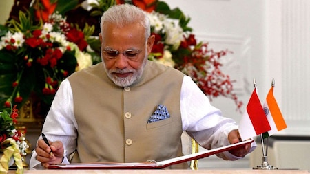 Prime Minister Narendra Modi signs the visitors book