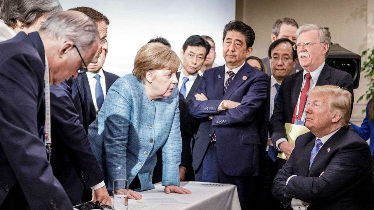 German Chancellor Angela Merkel speaking to President Donald Trump during the second day of the G7 meeting in Canada