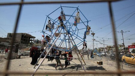 Children sit in mini ferris