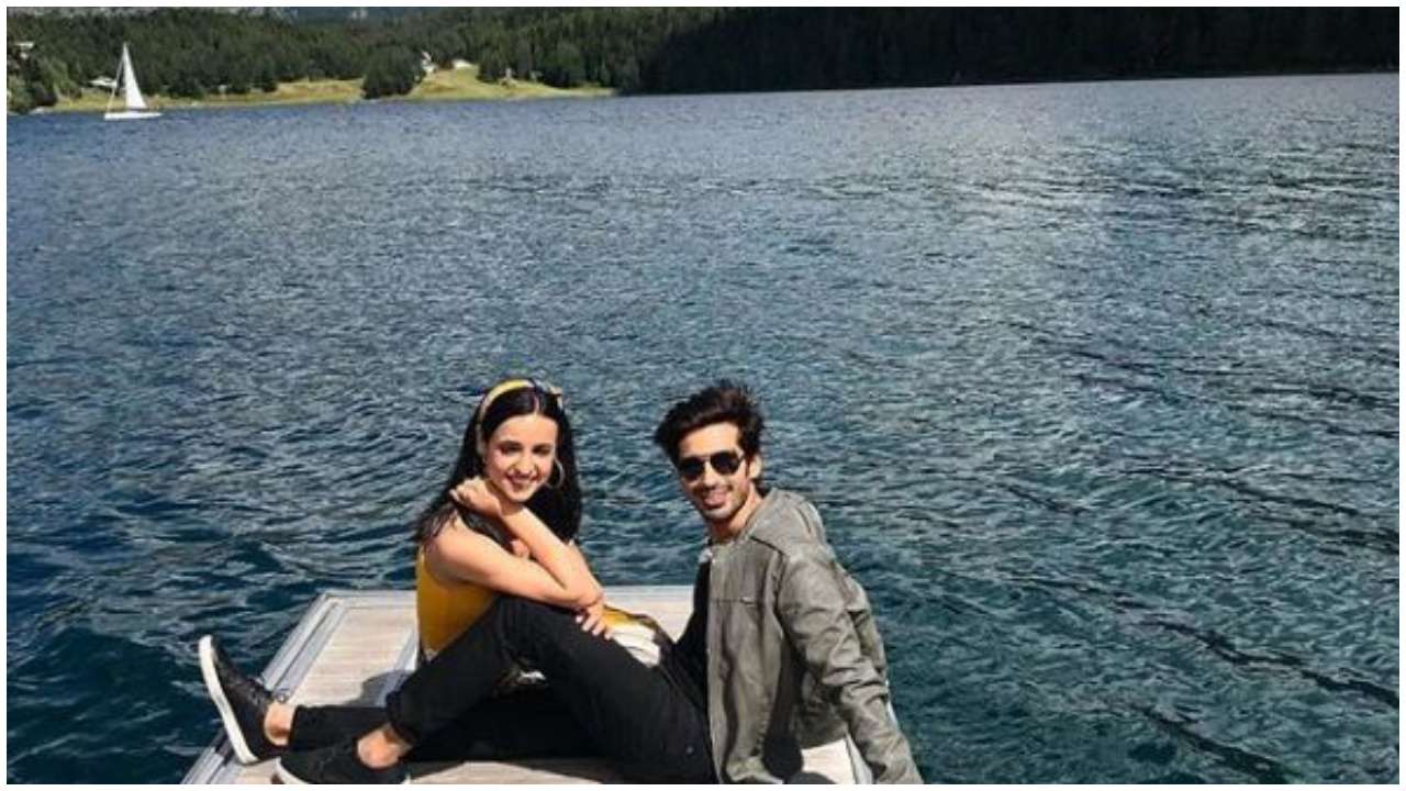 The couple enjoys some quiet time by the lake