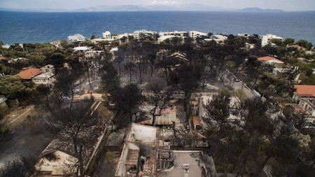 An aerial view shows burnt houses following a wildfire in the village of Mati