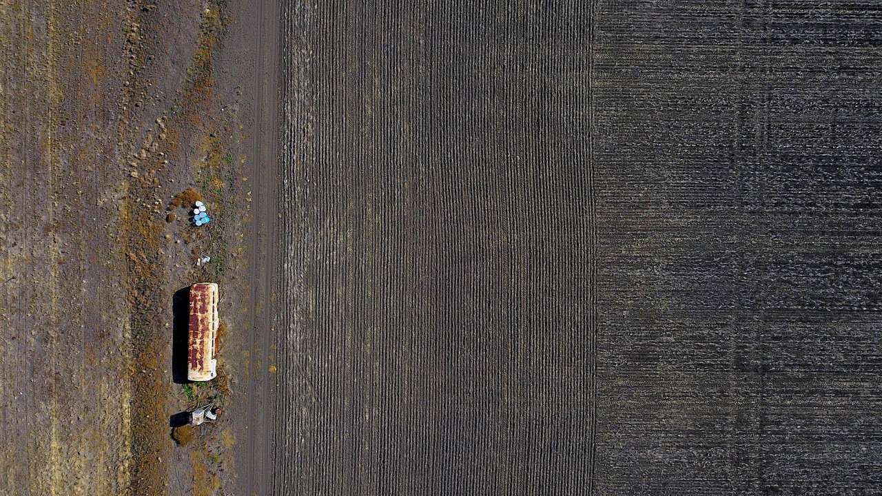 Farming equipment stands on a property of town of Gunnedah