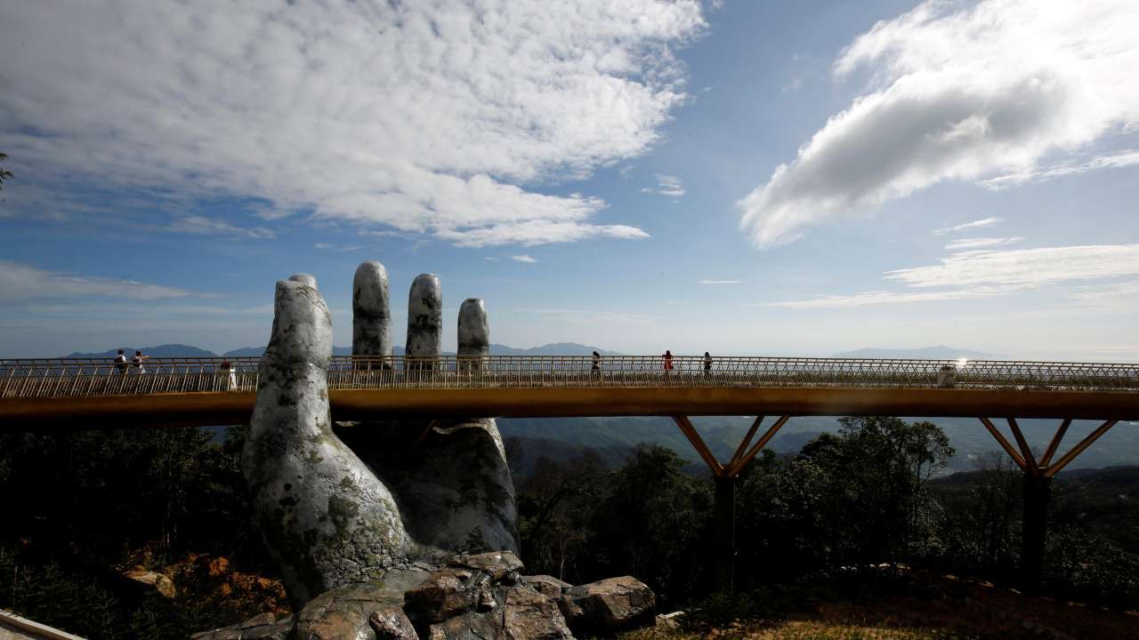 Tourists walk on Golden Bridge