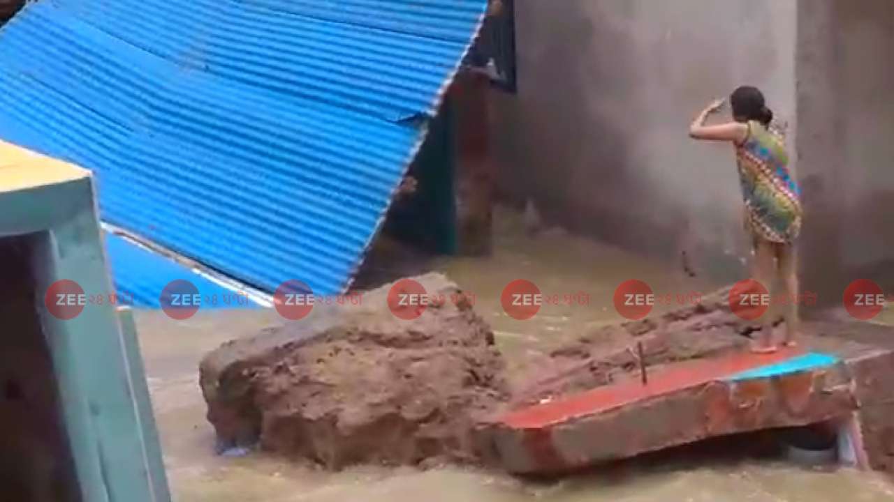 Hapless people look at ruins