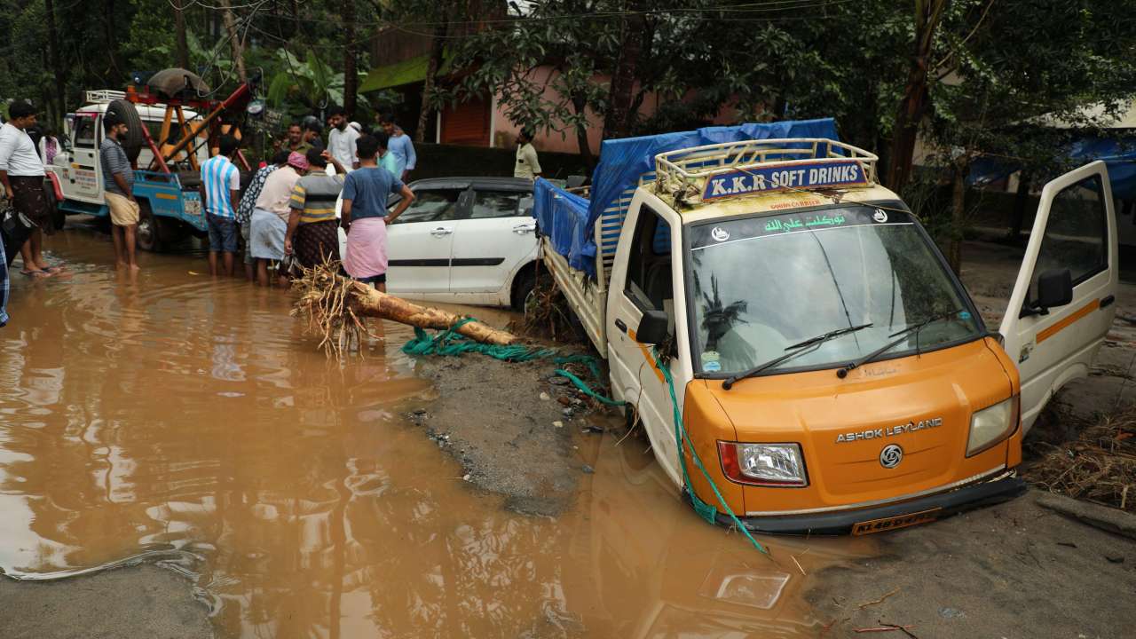 Vehicles stuck in the mud along a flooded road