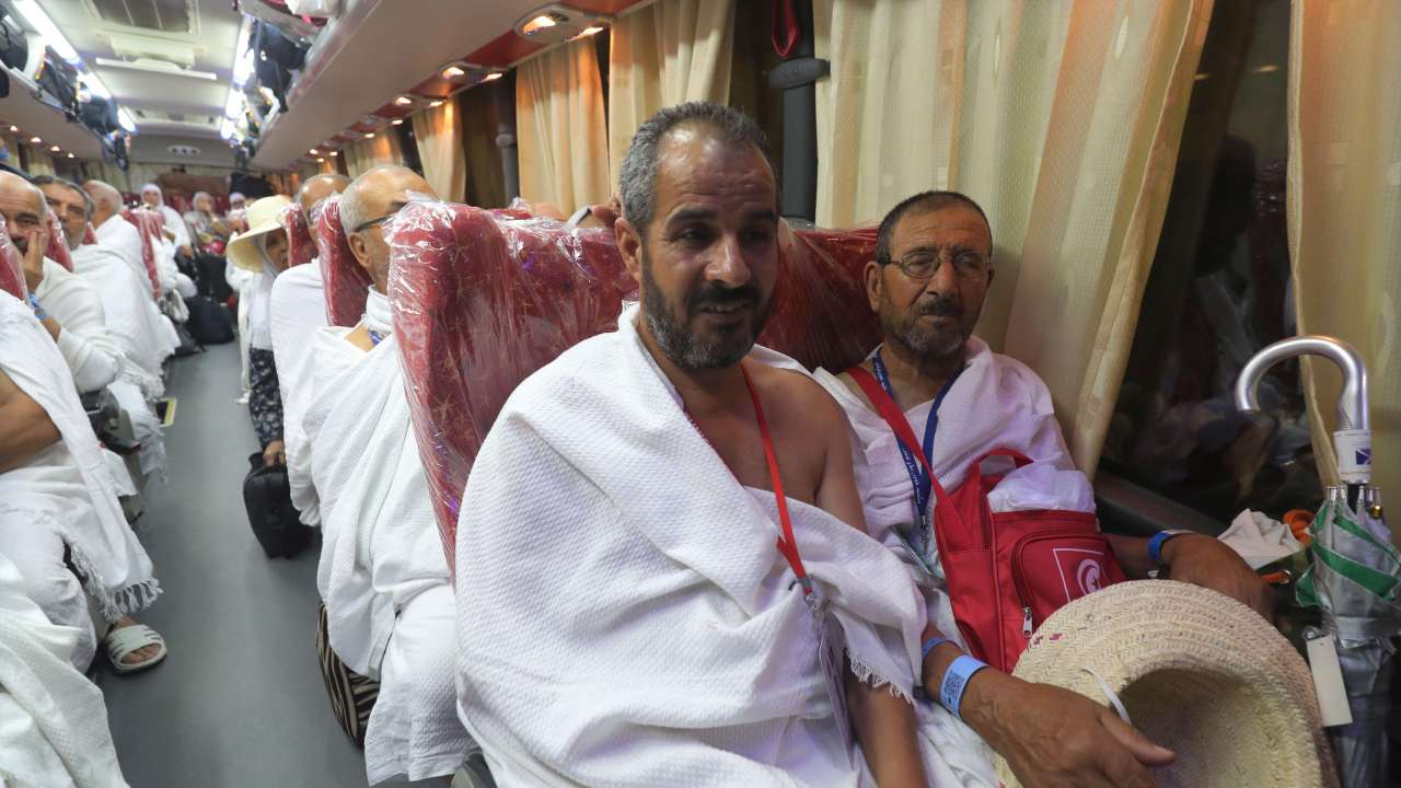 Muslim pilgrims gather in a bus