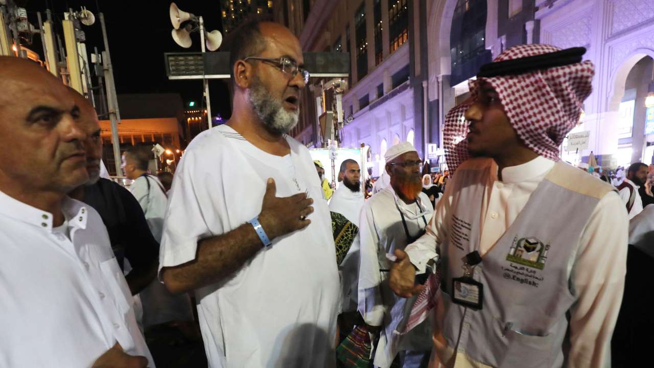 Muslim pilgrims speak to a translator