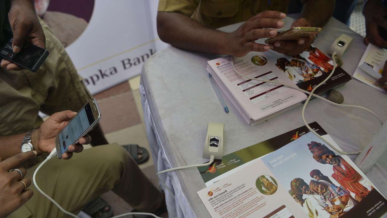 Indian post office employees help customers for opening new post office bank account India Post Payment Bank in Siliguri