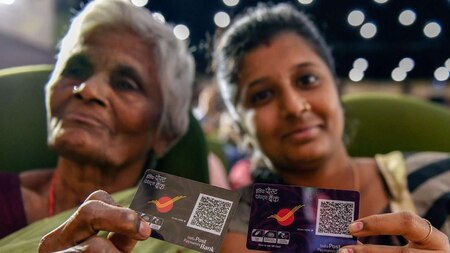 Beneficiaries display their digital QR code at the launch of India Post Payments Bank (IPPB), in Chennai on Saturday